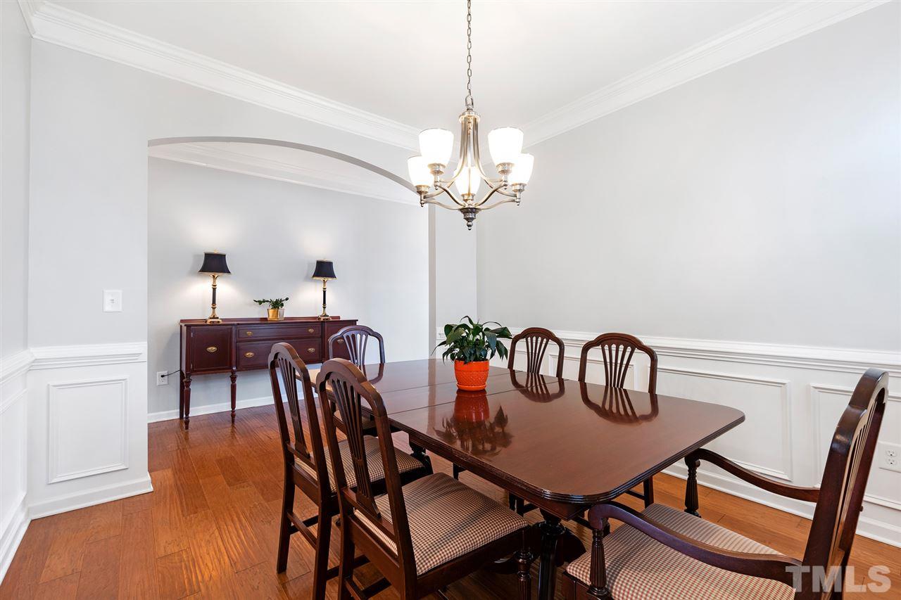 1013 Traditions Meadow Drive Wake Forest, NC 27587 - Photo 6 of 30 a view of a dining room with furniture and chandelier