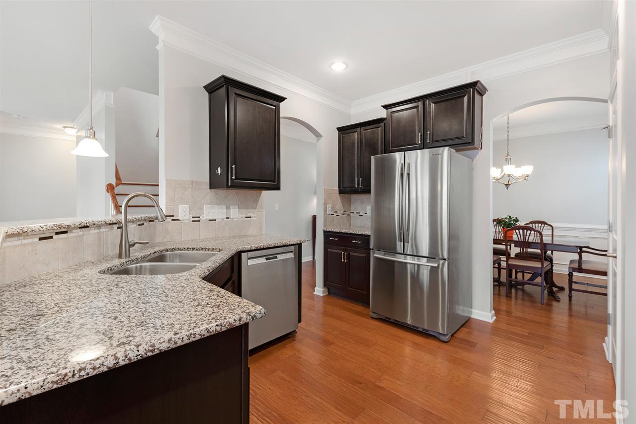 1013 Traditions Meadow Drive Wake Forest, NC 27587 - Photo 7 of 30 a kitchen with stainless steel appliances granite countertop a refrigerator and a stove top oven
