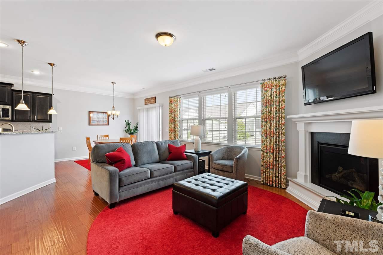 1013 Traditions Meadow Drive Wake Forest, NC 27587 - Photo 10 of 30 a living room with furniture fireplace and flat screen tv