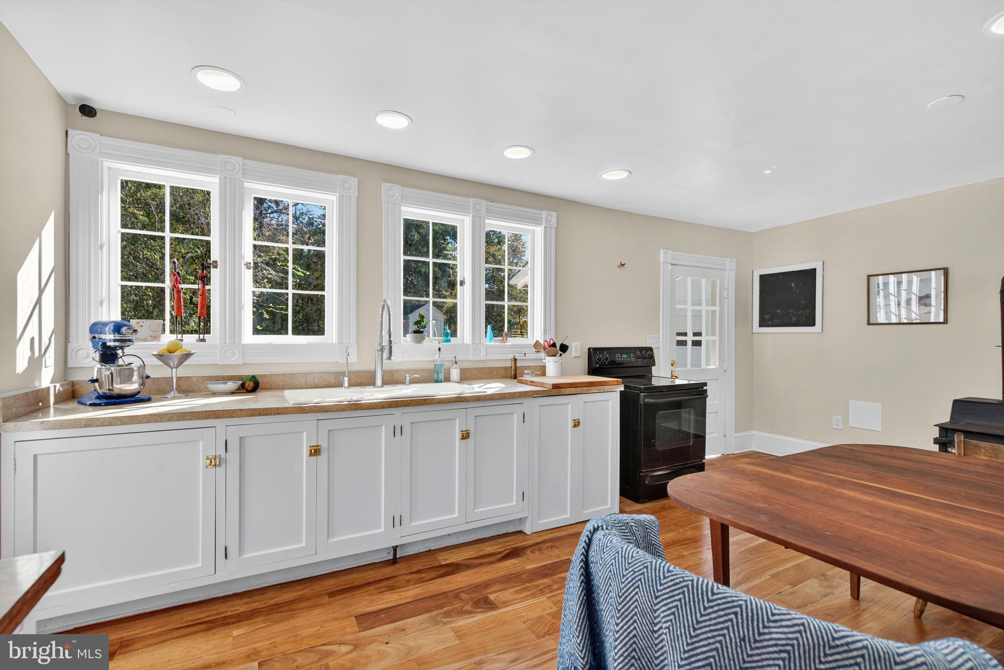 4561 Weston Road Catlett, VA 20119 - Photo 23 of 59 a kitchen with granite countertop a sink and dishwasher with wooden floor