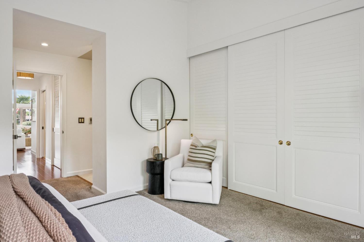 20 Porto Bello Drive San Rafael, CA 94901 - Photo 24 of 54 a bedroom with a bed a mirror and a chandelier
