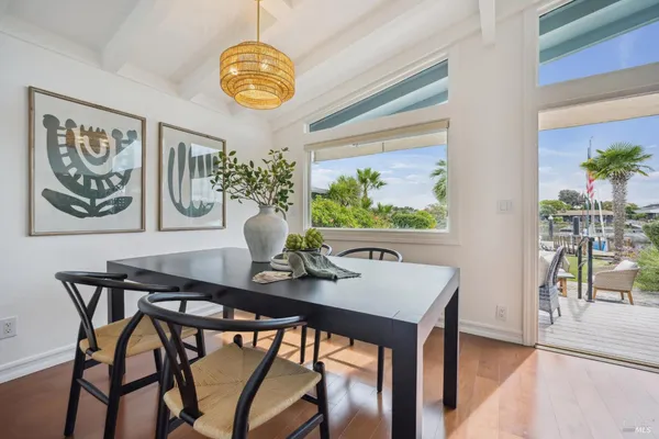 a view of a dining room with furniture and chandelier
