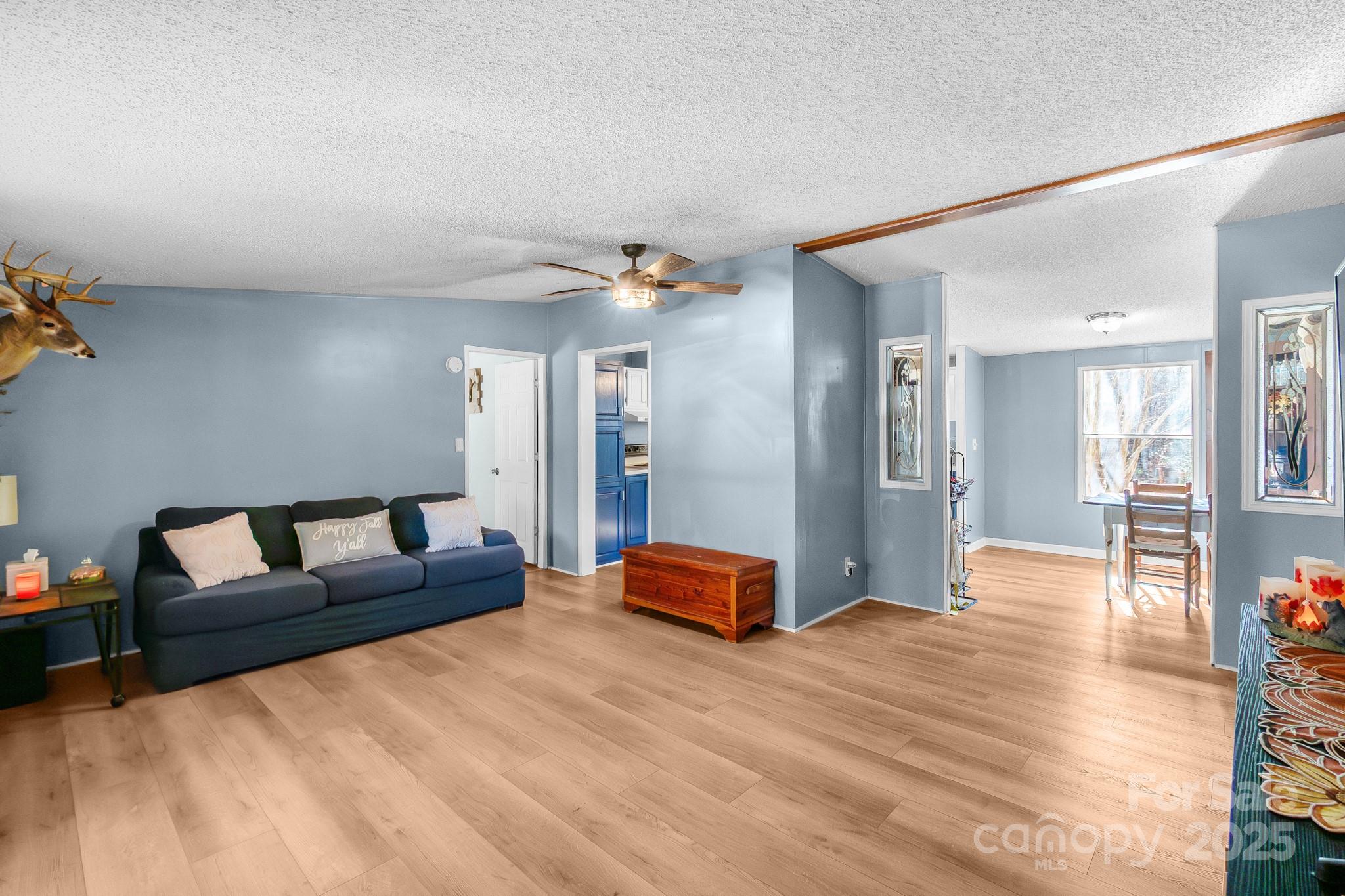 2214 Sojourn Road Marshville, NC 28103 - Photo 11 of 48 a living room with furniture and wooden floor