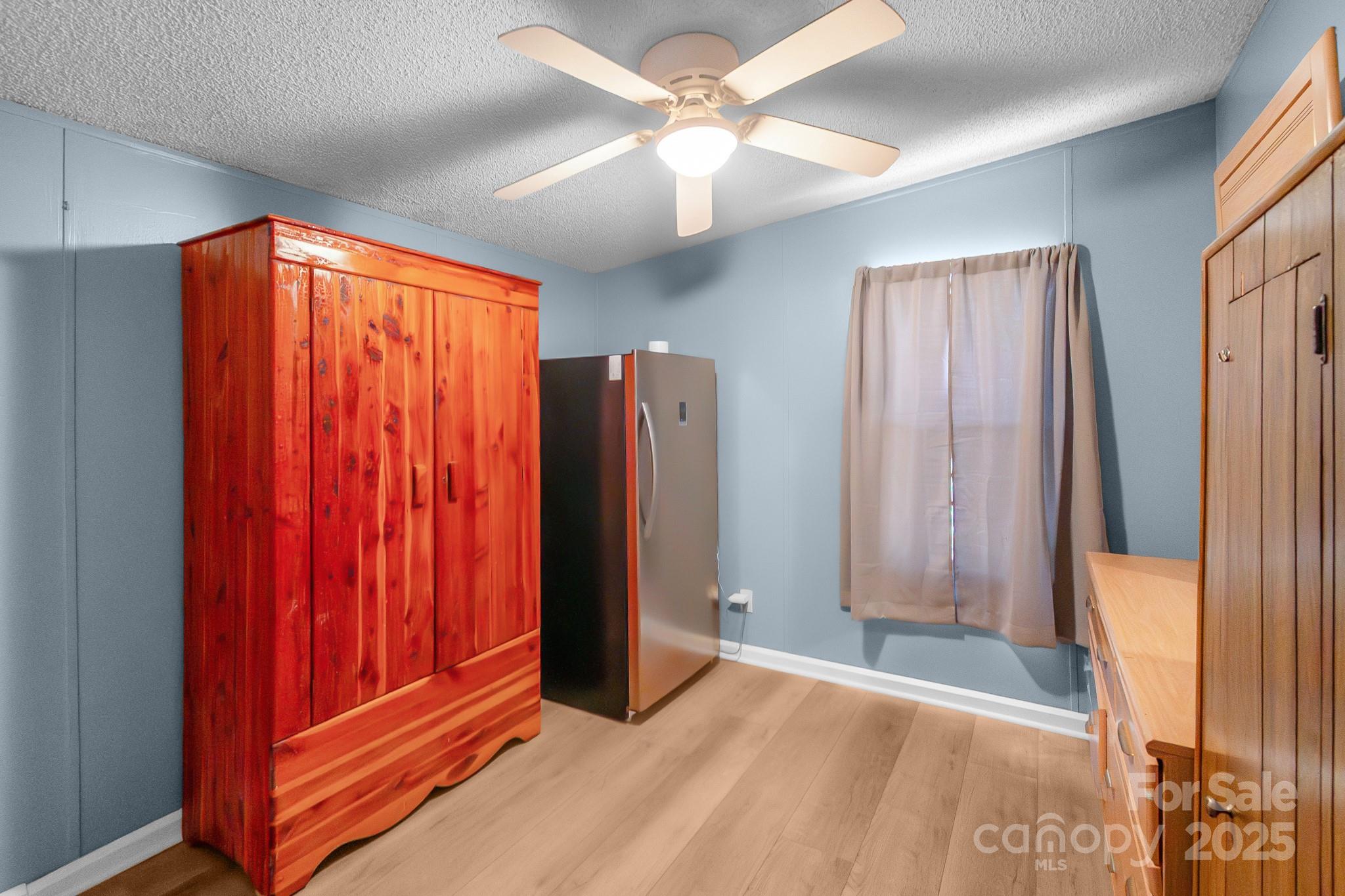2214 Sojourn Road Marshville, NC 28103 - Photo 13 of 48 a view of a room with a mirror and a ceiling fan