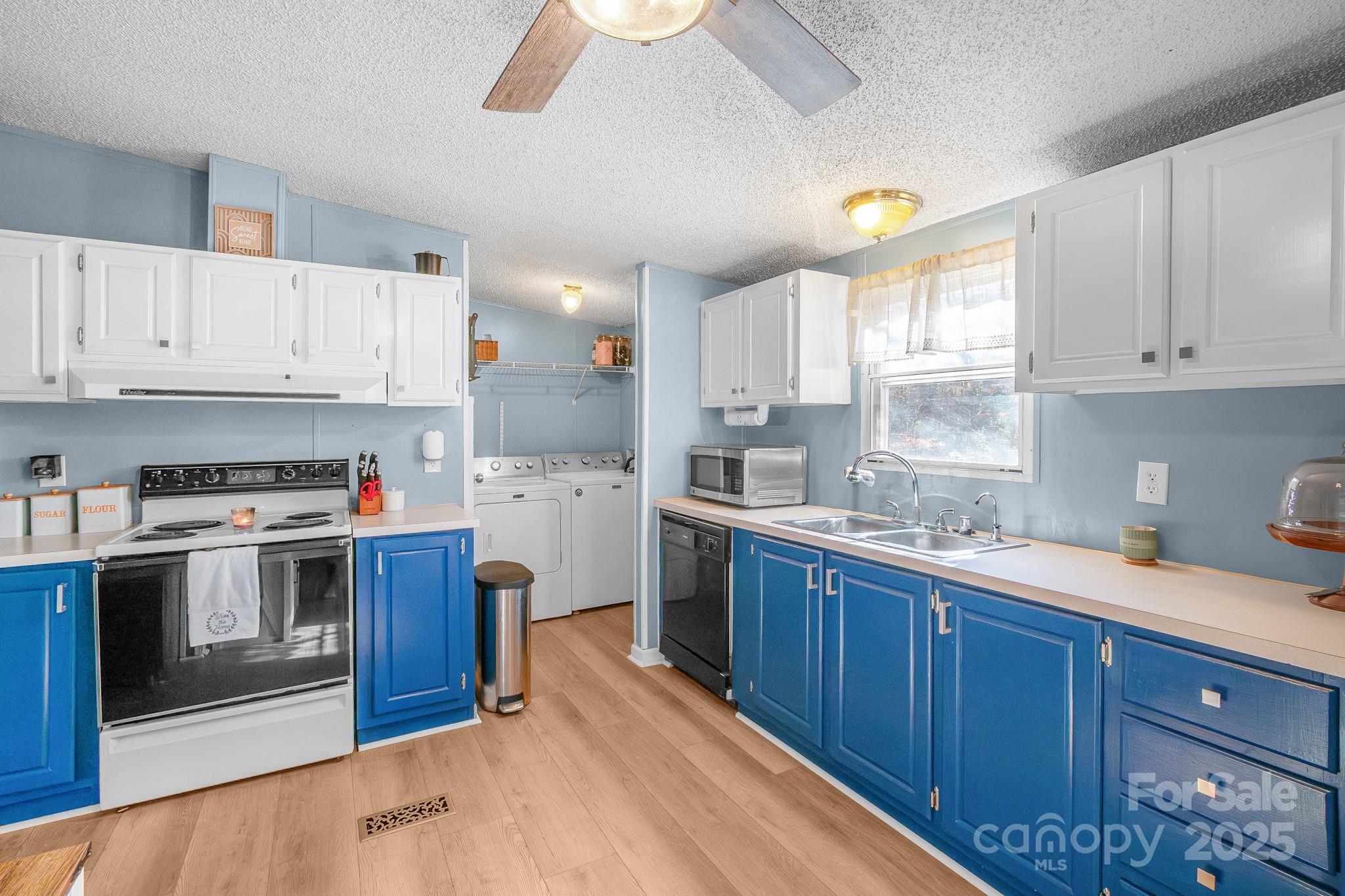 2214 Sojourn Road Marshville, NC 28103 - Photo 20 of 48 a kitchen with kitchen island granite countertop a sink stainless steel appliances and cabinets