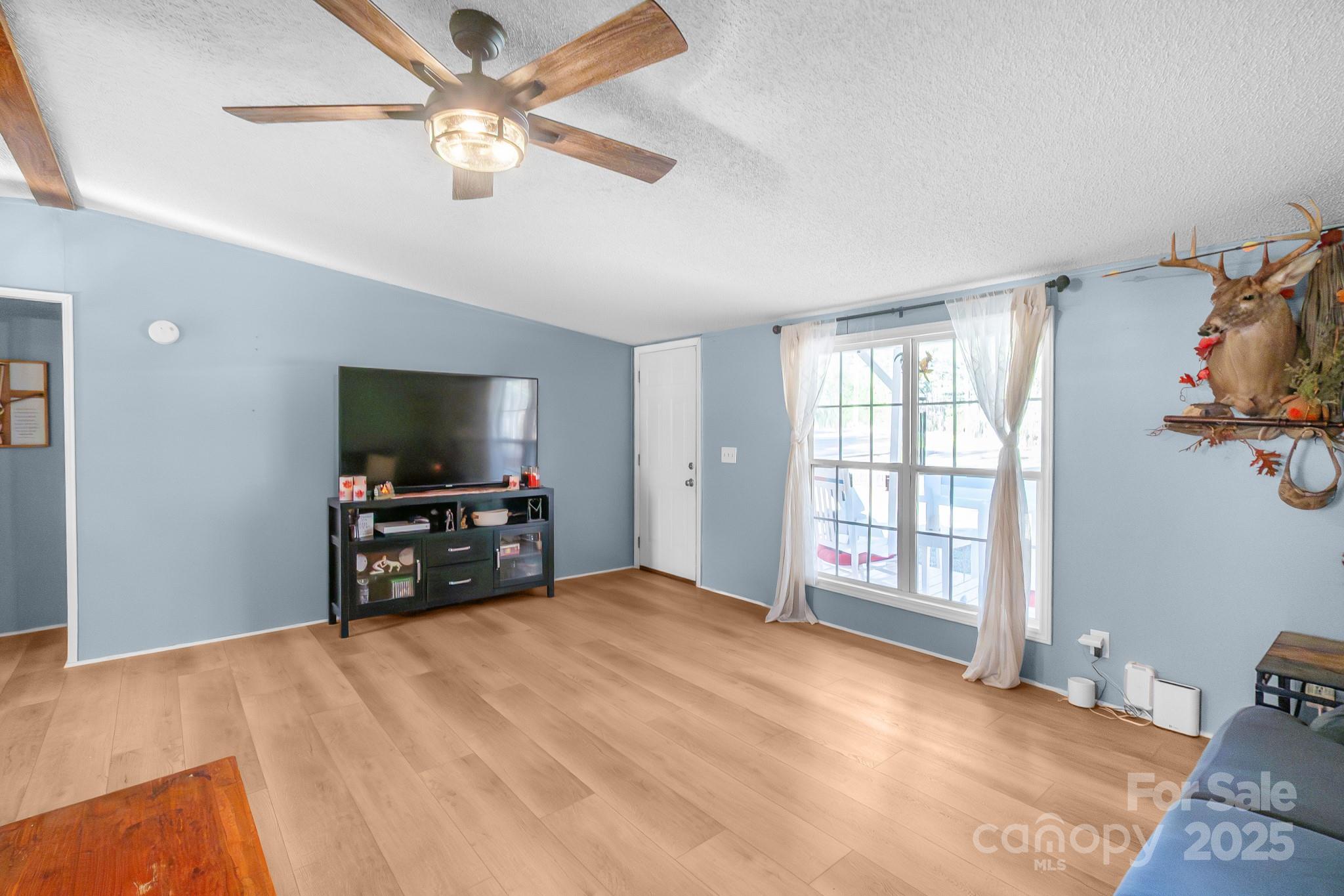 2214 Sojourn Road Marshville, NC 28103 - Photo 2 of 48 a bedroom with a bed and a flat screen tv