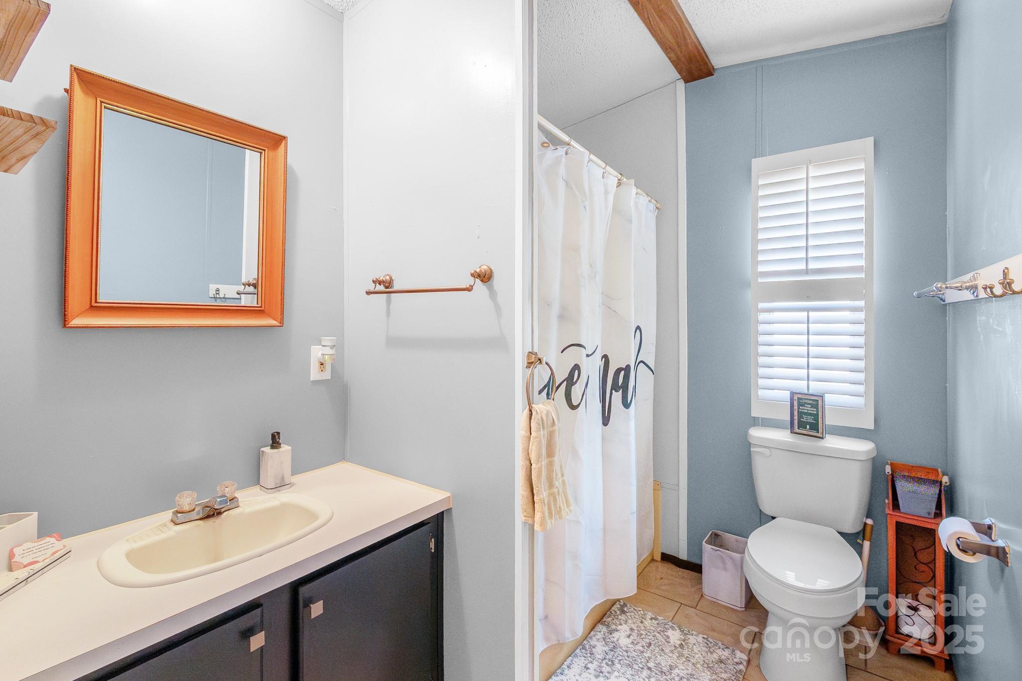 2214 Sojourn Road Marshville, NC 28103 - Photo 29 of 48 a bathroom with a sink toilet and shower