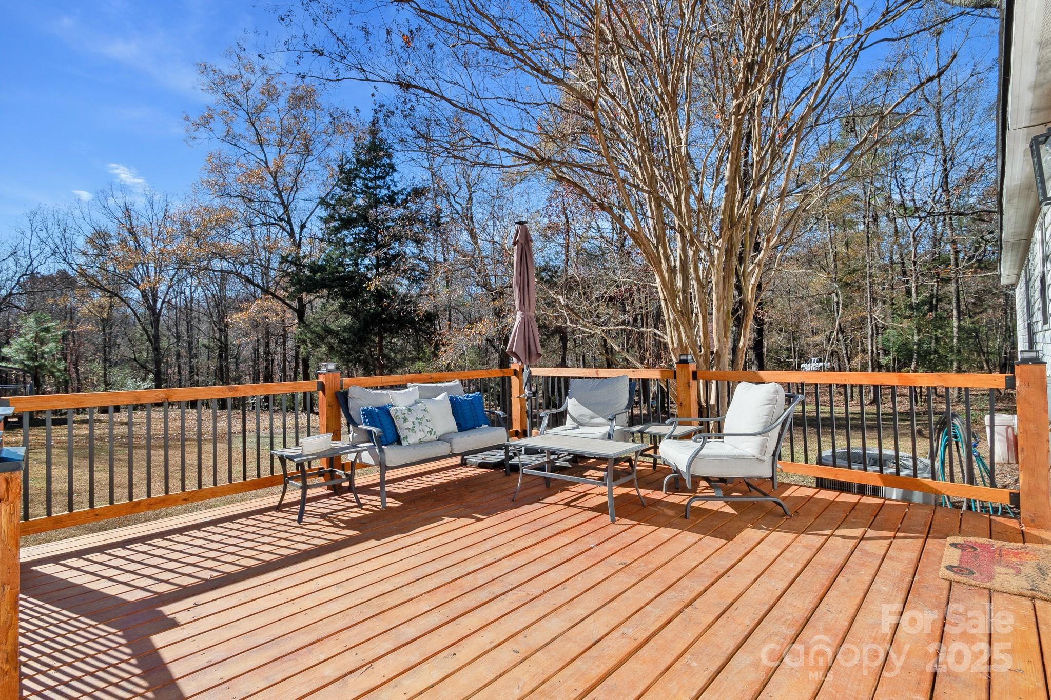 2214 Sojourn Road Marshville, NC 28103 - Photo 32 of 48 a view of roof deck with wooden floor and outdoor seating
