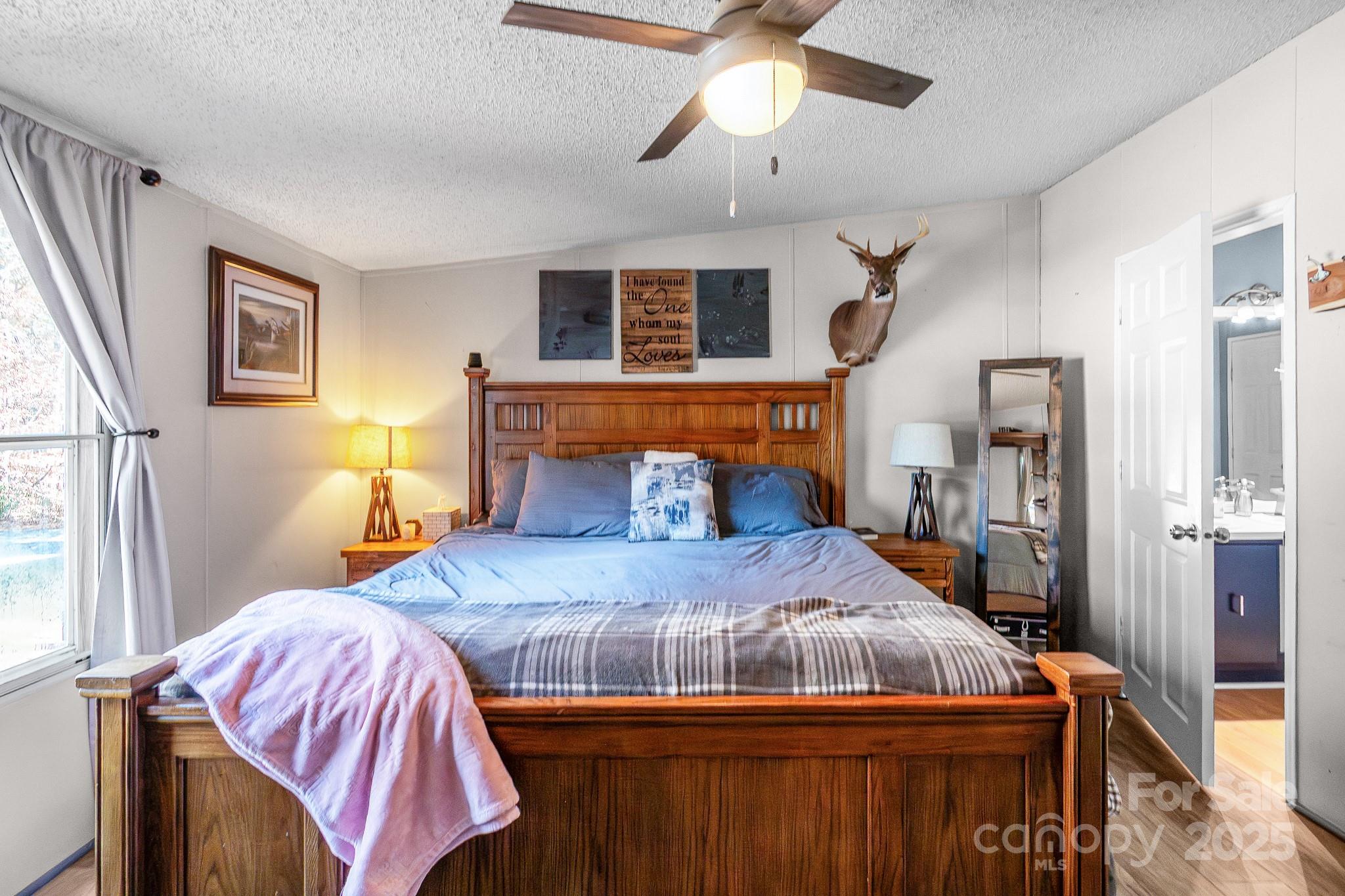 2214 Sojourn Road Marshville, NC 28103 - Photo 5 of 48 a bedroom with a bed and wooden floor