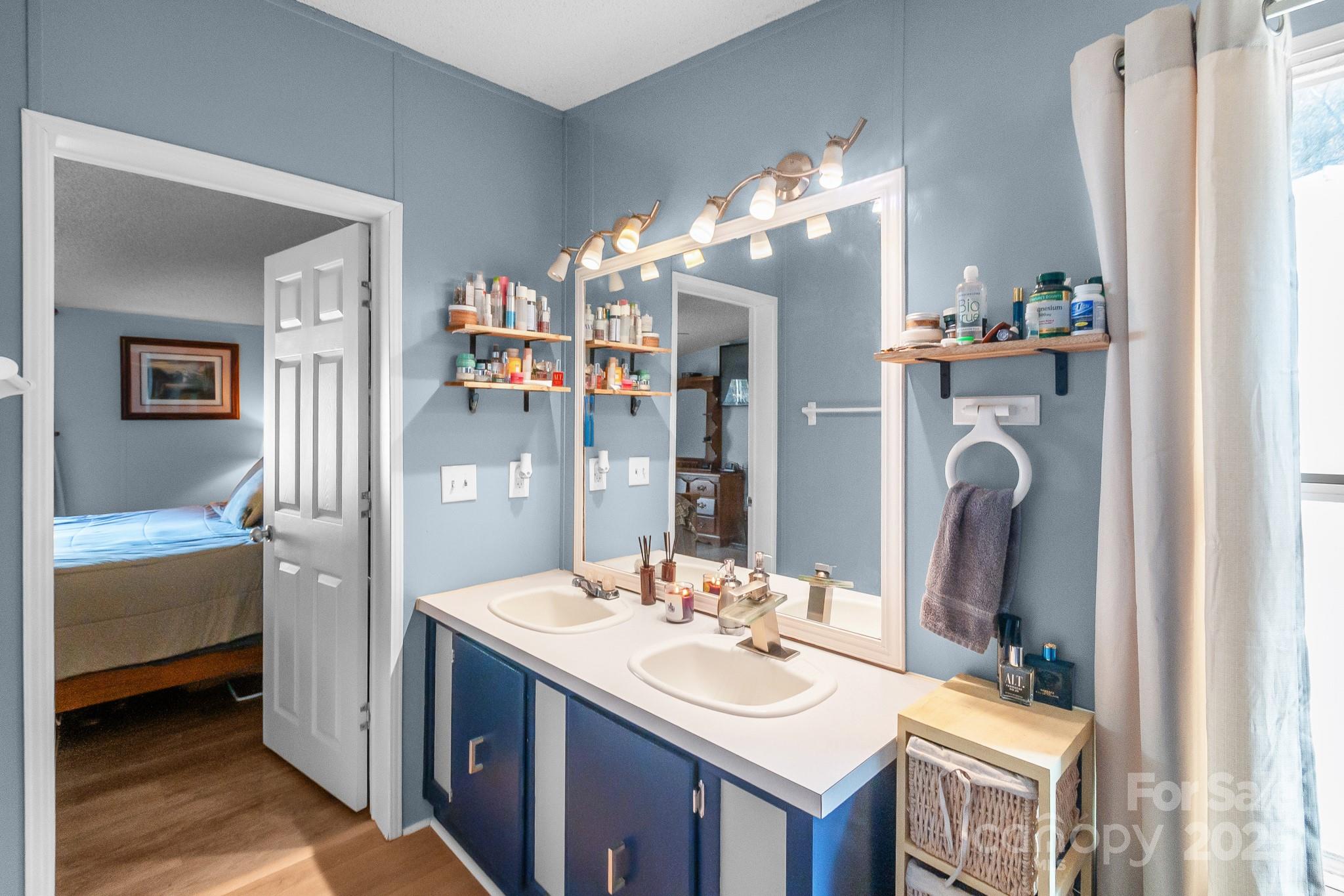 2214 Sojourn Road Marshville, NC 28103 - Photo 7 of 48 a bathroom with a sink double vanity and a mirror