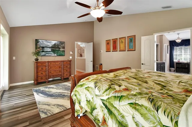 a bedroom with bed and wooden floor