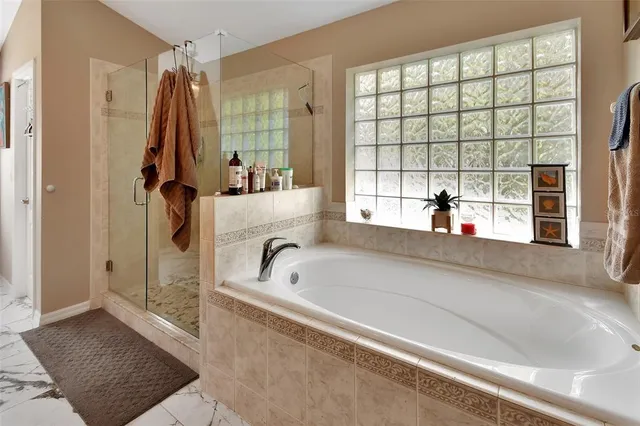a bathroom with a bathtub and a shower