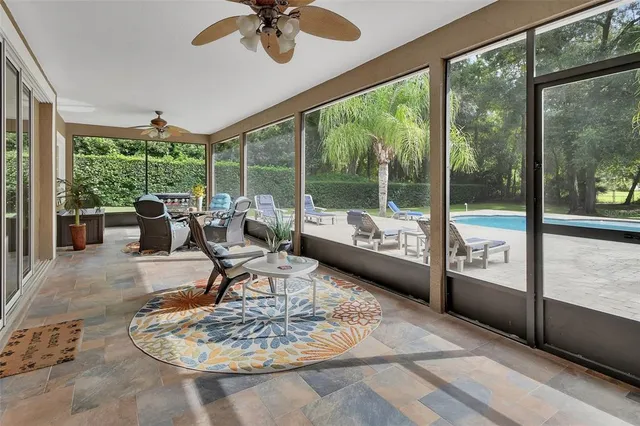 an aerial view of residential house with outdoor space and trees all around