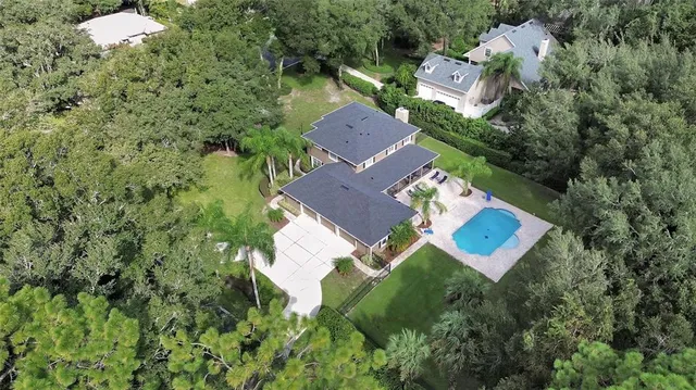 a front view of a house with a garden and plants