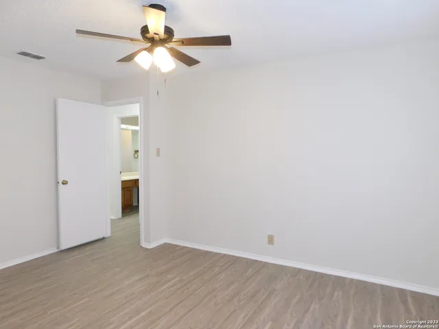 a view of an empty room with a fan
