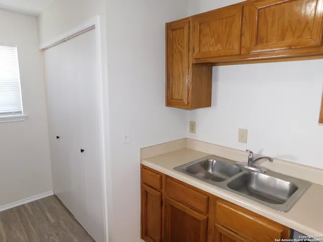 a kitchen with a sink and cabinets