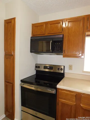 a kitchen with a stove and a microwave