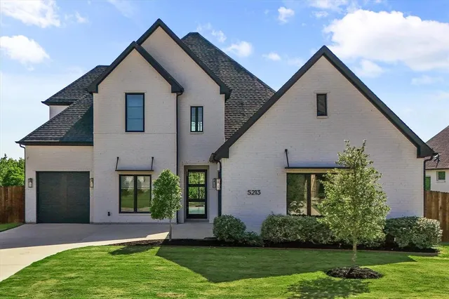 a view of a yard in front view of a house