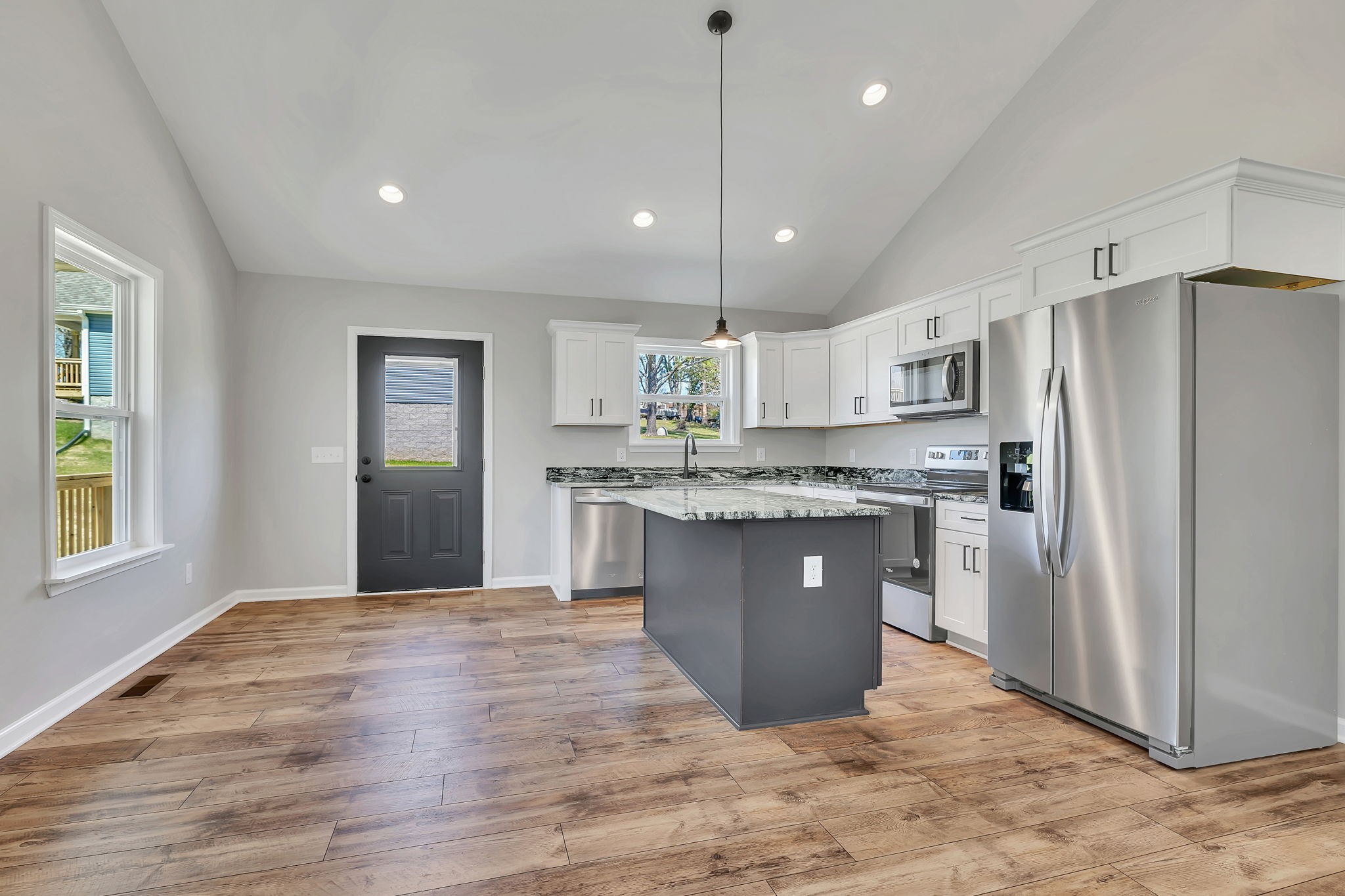 127 Lock 6 Road Hartsville, TN 37074 - Photo 14 of 35 a large kitchen with stainless steel appliances granite countertop a refrigerator a sink dishwasher a stove and white countertops with wooden floor