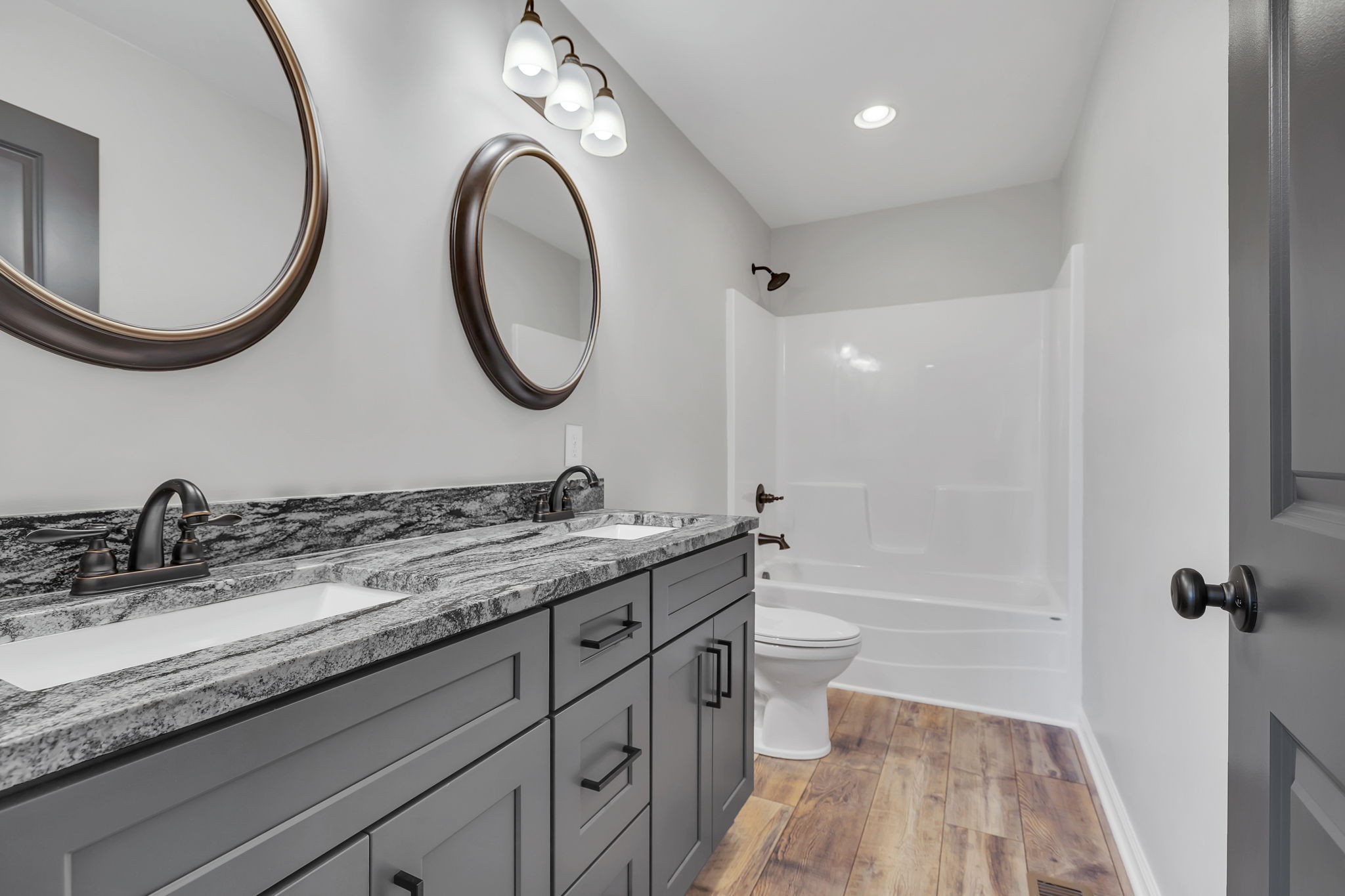 127 Lock 6 Road Hartsville, TN 37074 - Photo 24 of 35 a bathroom with a granite countertop toilet sink and mirror