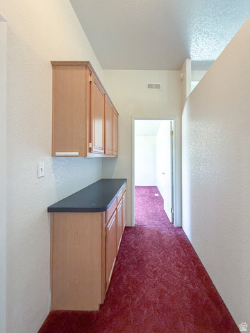 141 South 100 East Emery, UT 84522 - Photo 9 of 17 Built-in cabinetry with light wood-finish doors and dark countertops provides extensive storage
