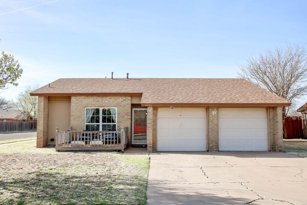 6001 14th Street Lubbock, TX 79416 - Photo 1 of 31 a front view of a house with a yard and garage