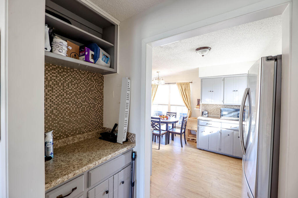 6001 14th Street Lubbock, TX 79416 - Photo 13 of 31 a kitchen with granite countertop a refrigerator a sink and a stove