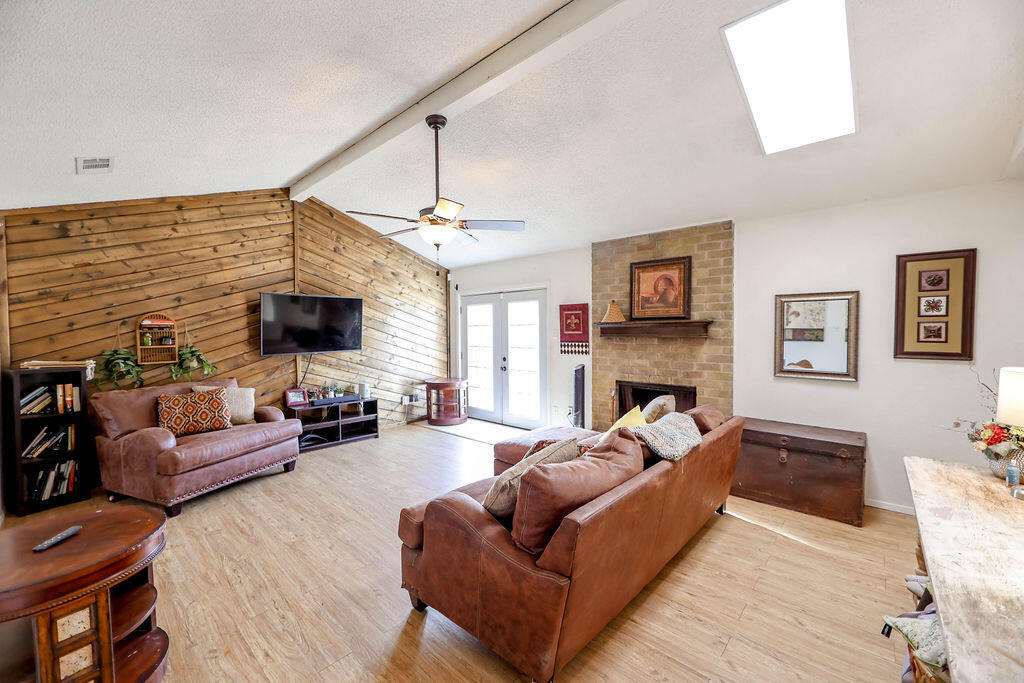 6001 14th Street Lubbock, TX 79416 - Photo 14 of 31 a living room with furniture and a flat screen tv