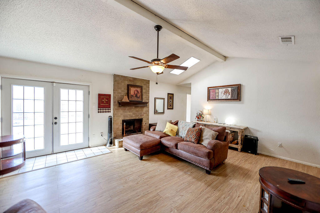 6001 14th Street Lubbock, TX 79416 - Photo 16 of 31 a living room with furniture and a fireplace