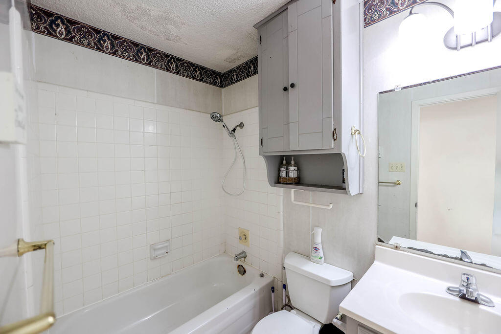 6001 14th Street Lubbock, TX 79416 - Photo 18 of 31 a bathroom with a toilet a sink and bathtub