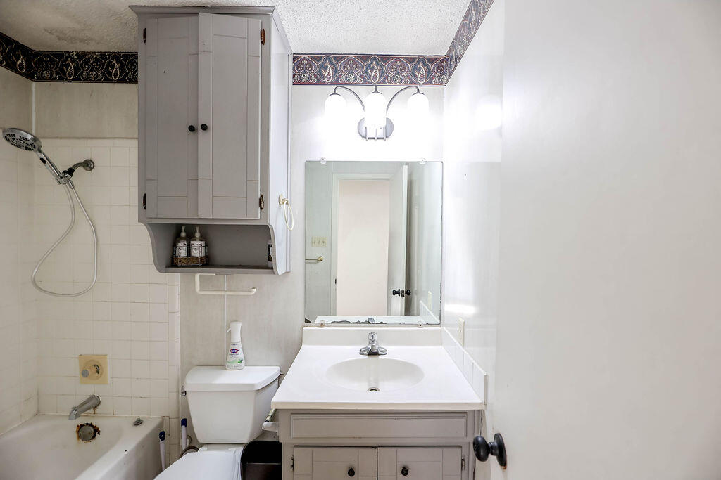 6001 14th Street Lubbock, TX 79416 - Photo 19 of 31 a bathroom with a sink a toilet and shower