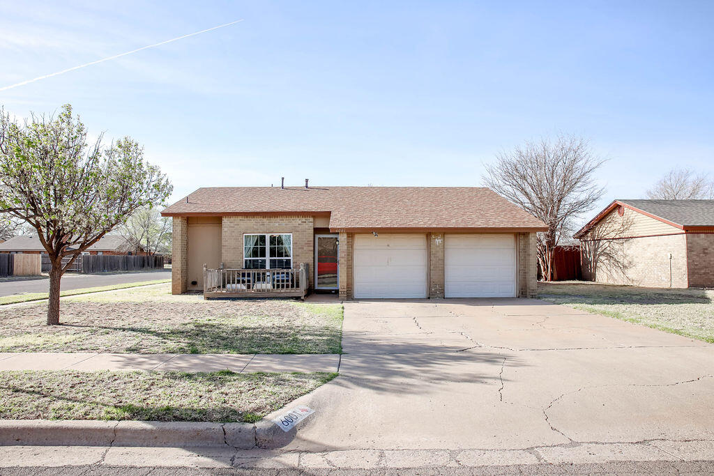 6001 14th Street Lubbock, TX 79416 - Photo 2 of 31 a front view of a house with a yard and garage
