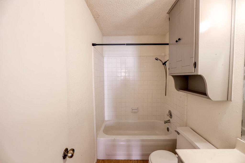 6001 14th Street Lubbock, TX 79416 - Photo 27 of 31 a bathroom with a toilet bathtub and shower