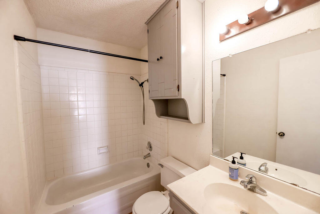 6001 14th Street Lubbock, TX 79416 - Photo 28 of 31 a bathroom with a bathtub shower sink and a toilet