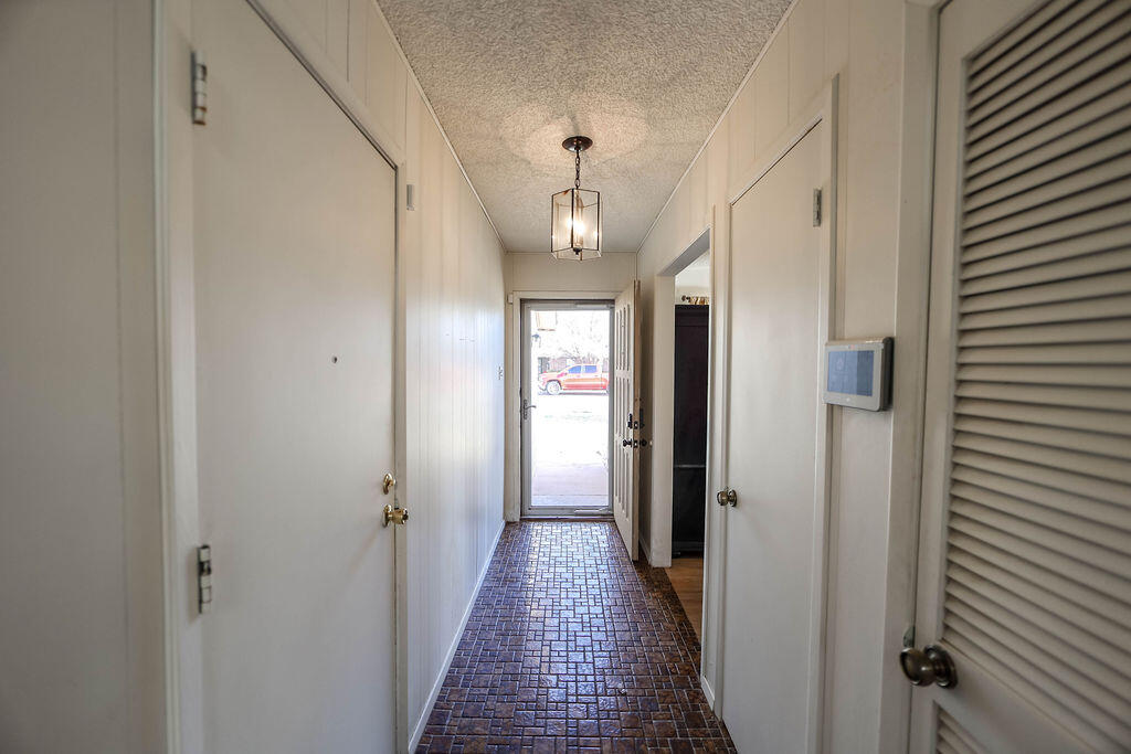 6001 14th Street Lubbock, TX 79416 - Photo 7 of 31 a view of a hallway with wooden floor and closet