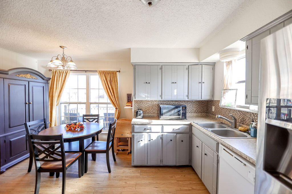 6001 14th Street Lubbock, TX 79416 - Photo 9 of 31 a kitchen that has a dining table and chairs in it