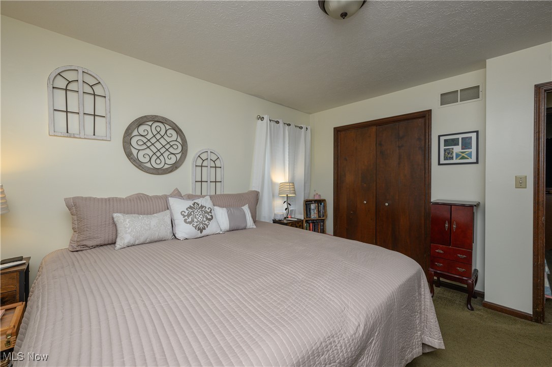2667 Deibel Road Clinton, OH 44216 - Photo 17 of 23 Bedroom with a textured ceiling, a closet, and carpet flooring