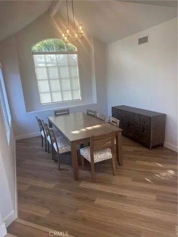 a view of a dining room with furniture and chandelier