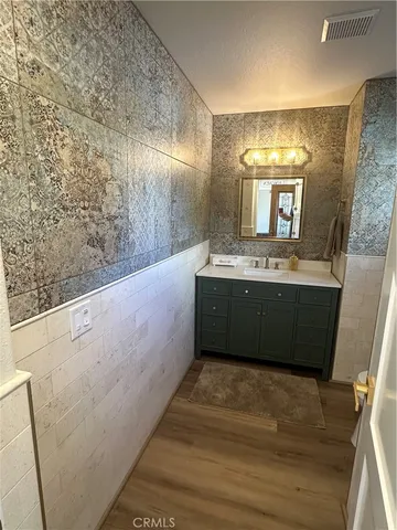 a bathroom with a sink a mirror and a bathtub