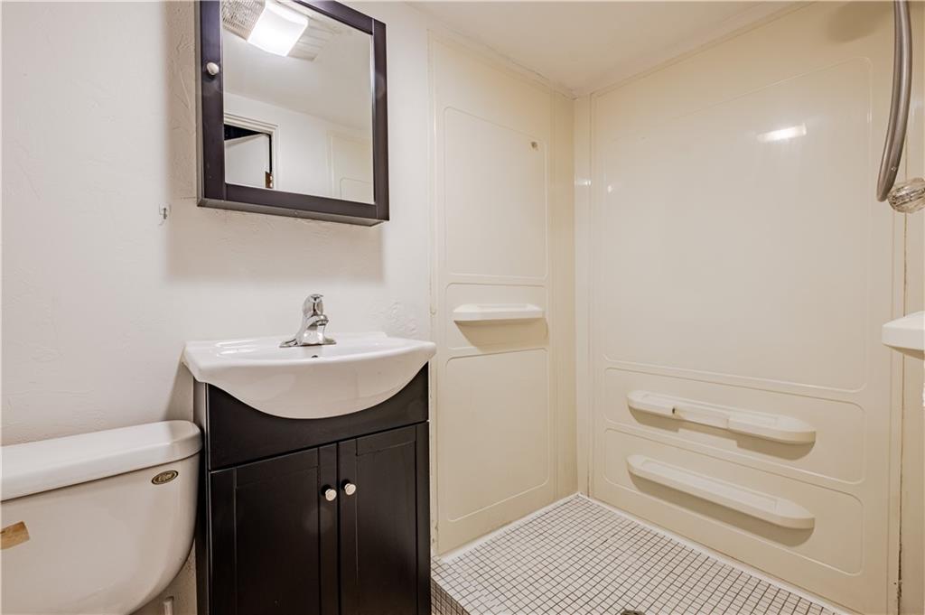 435 Pearce Road Pittsburgh, PA 15234 - Photo 22 of 25 a bathroom with a sink a toilet and a mirror