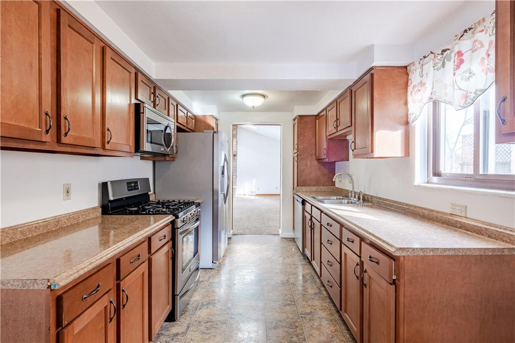 435 Pearce Road Pittsburgh, PA 15234 - Photo 6 of 25 a kitchen with stainless steel appliances granite countertop a stove a sink dishwasher and a refrigerator