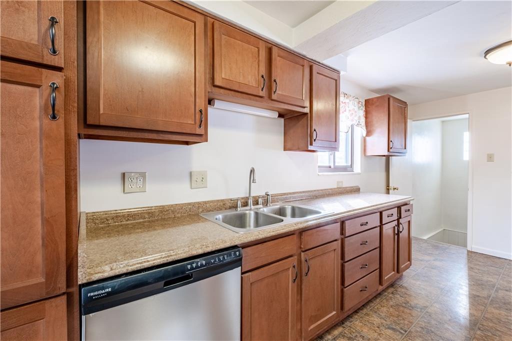 435 Pearce Road Pittsburgh, PA 15234 - Photo 8 of 25 a kitchen with stainless steel appliances granite countertop a sink stove and cabinets