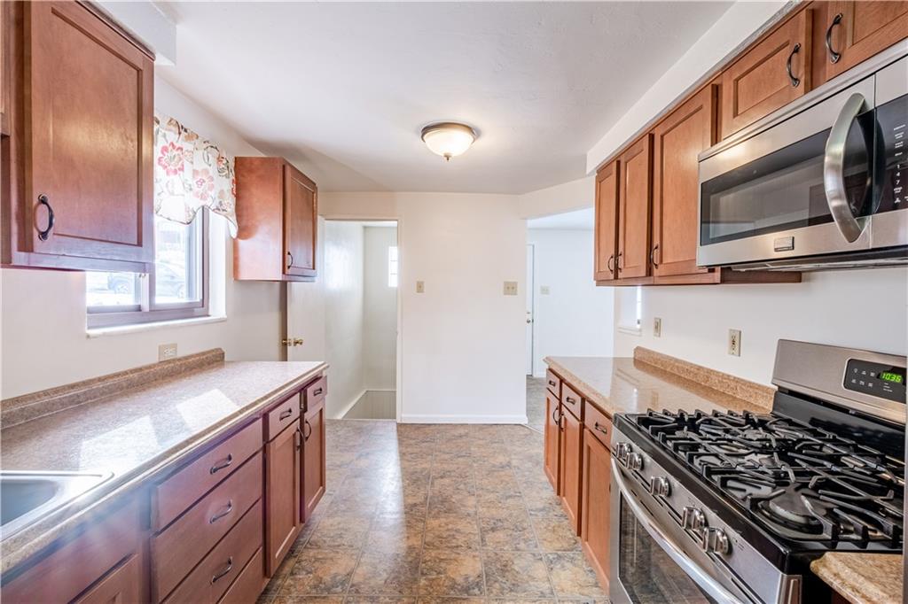 435 Pearce Road Pittsburgh, PA 15234 - Photo 9 of 25 a kitchen with stainless steel appliances granite countertop a stove a sink and a microwave