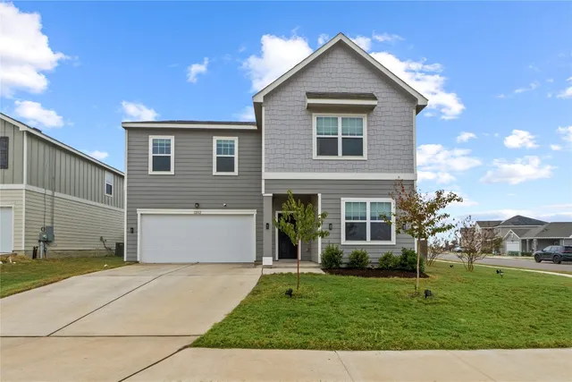 a front view of a house with a yard