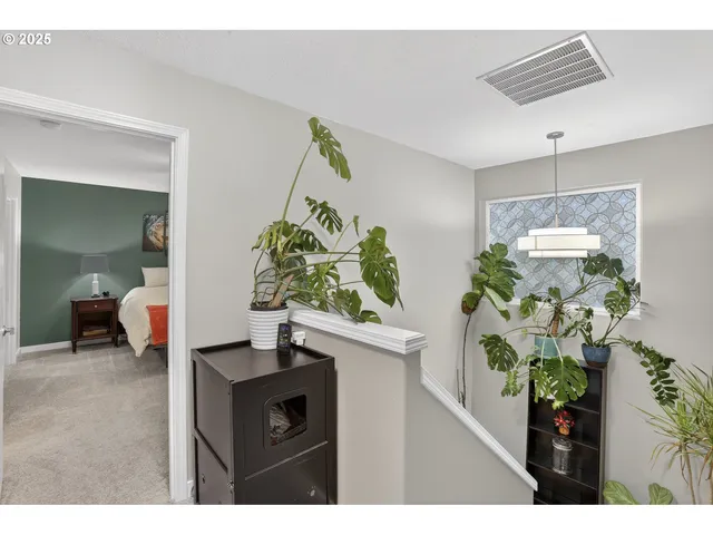 a view of living room filled with furniture and a potted plant