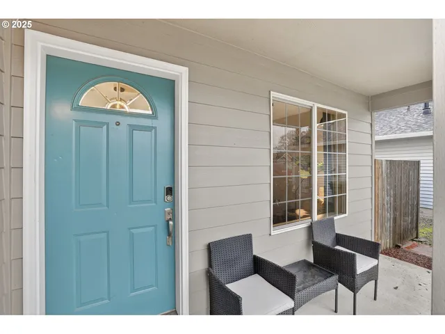 a front view of a house with a black gate