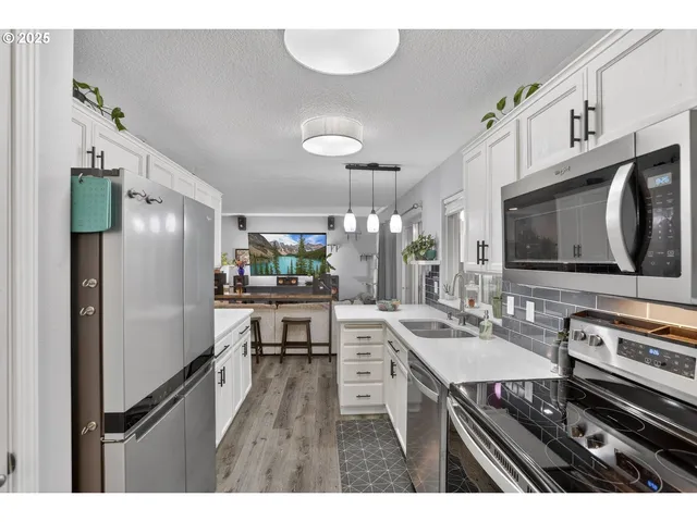 a kitchen with kitchen island a stove and a refrigerator