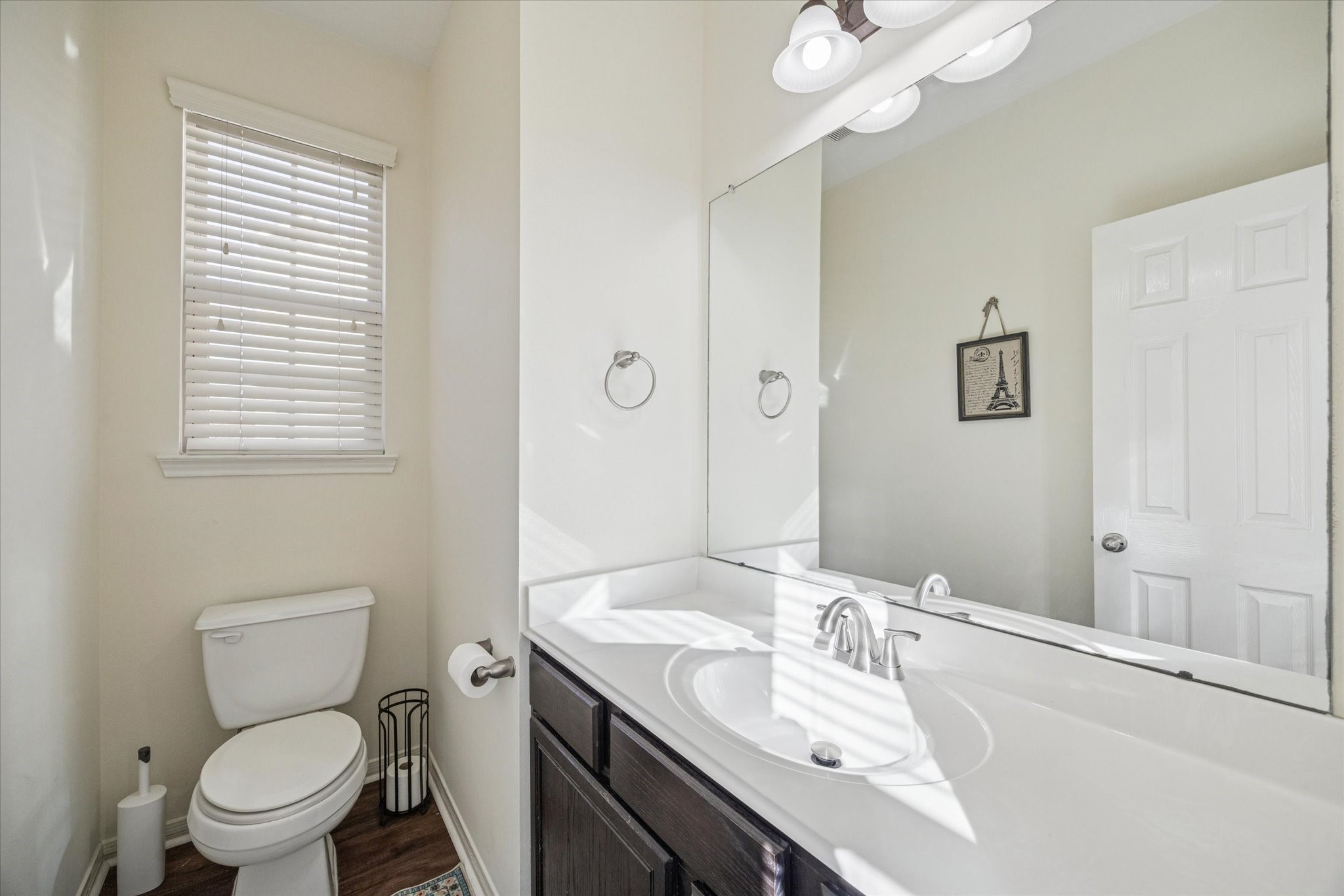 3332 Home Point Drive Houston, TX 77091 - Photo 14 of 26 a bathroom with a granite countertop toilet a sink a mirror and a window