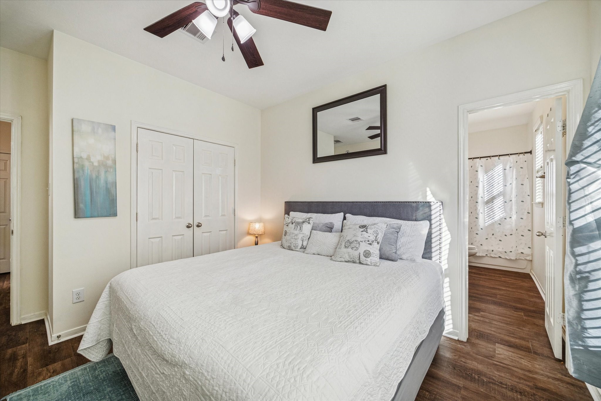 3332 Home Point Drive Houston, TX 77091 - Photo 22 of 26 a bedroom with a large bed and a chandelier