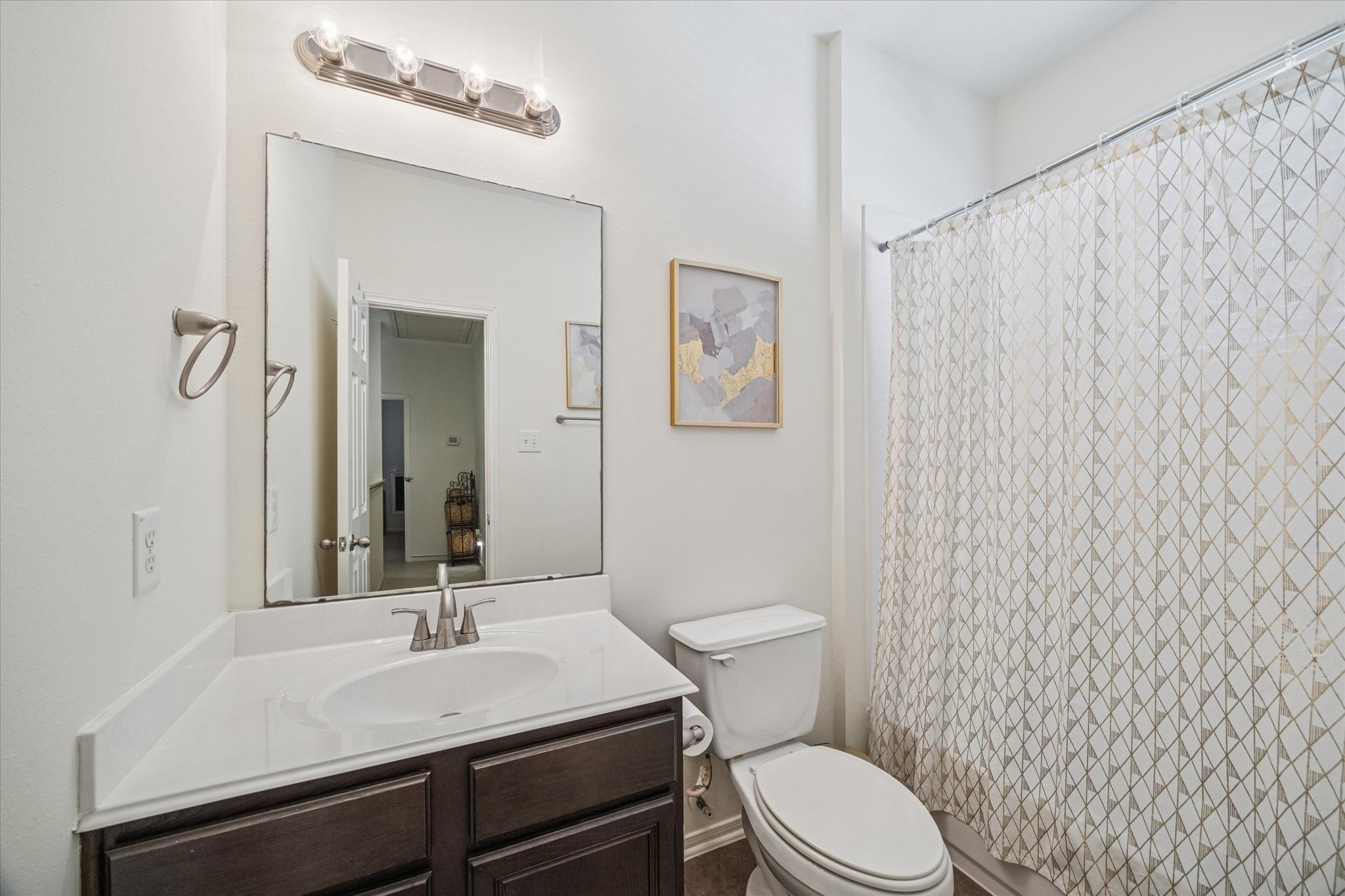 3332 Home Point Drive Houston, TX 77091 - Photo 24 of 26 a bathroom with a sink a toilet a mirror and shower curtain